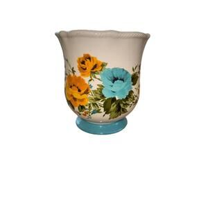 Pioneer Woman Rose Shadow Canister with a floral design and a teal footed base.